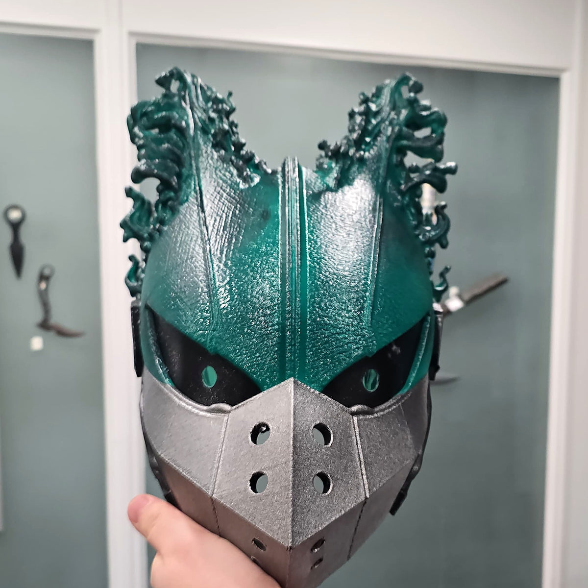 Painted Dark Deku helmet held in hand, original photo